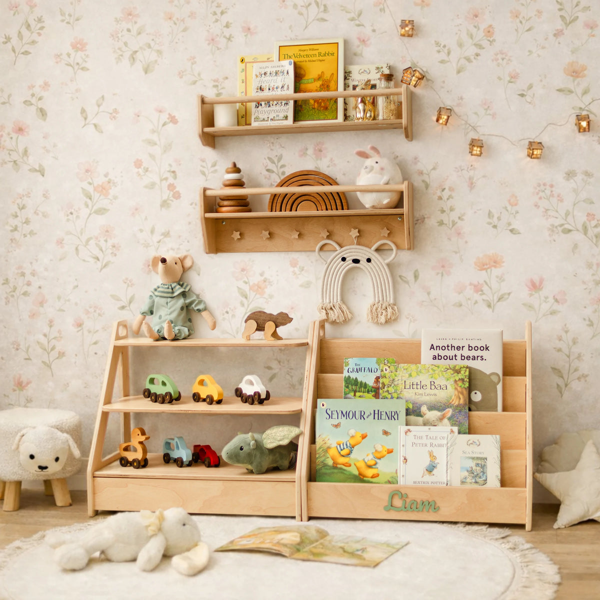 Personalized light wood toy shelf and bookshelf set in a nursery with floral wallpaper, wooden toys and books