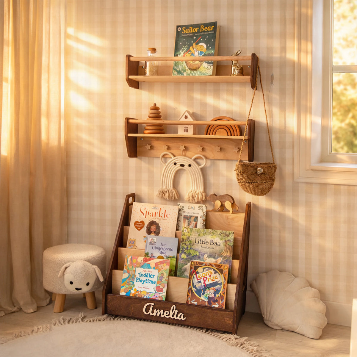 Light wood nursery wall shelves with books and toys above a floor bookshelf in a sunlit kids room