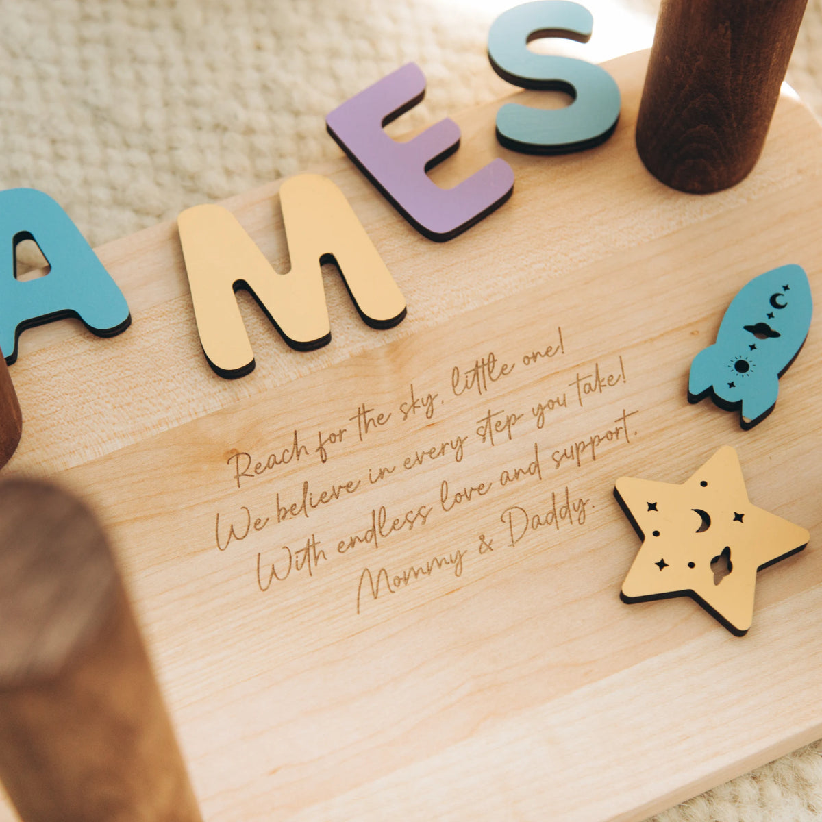 Close up of a personalized engraved secret message on the bottom of a wooden nursery step stool.