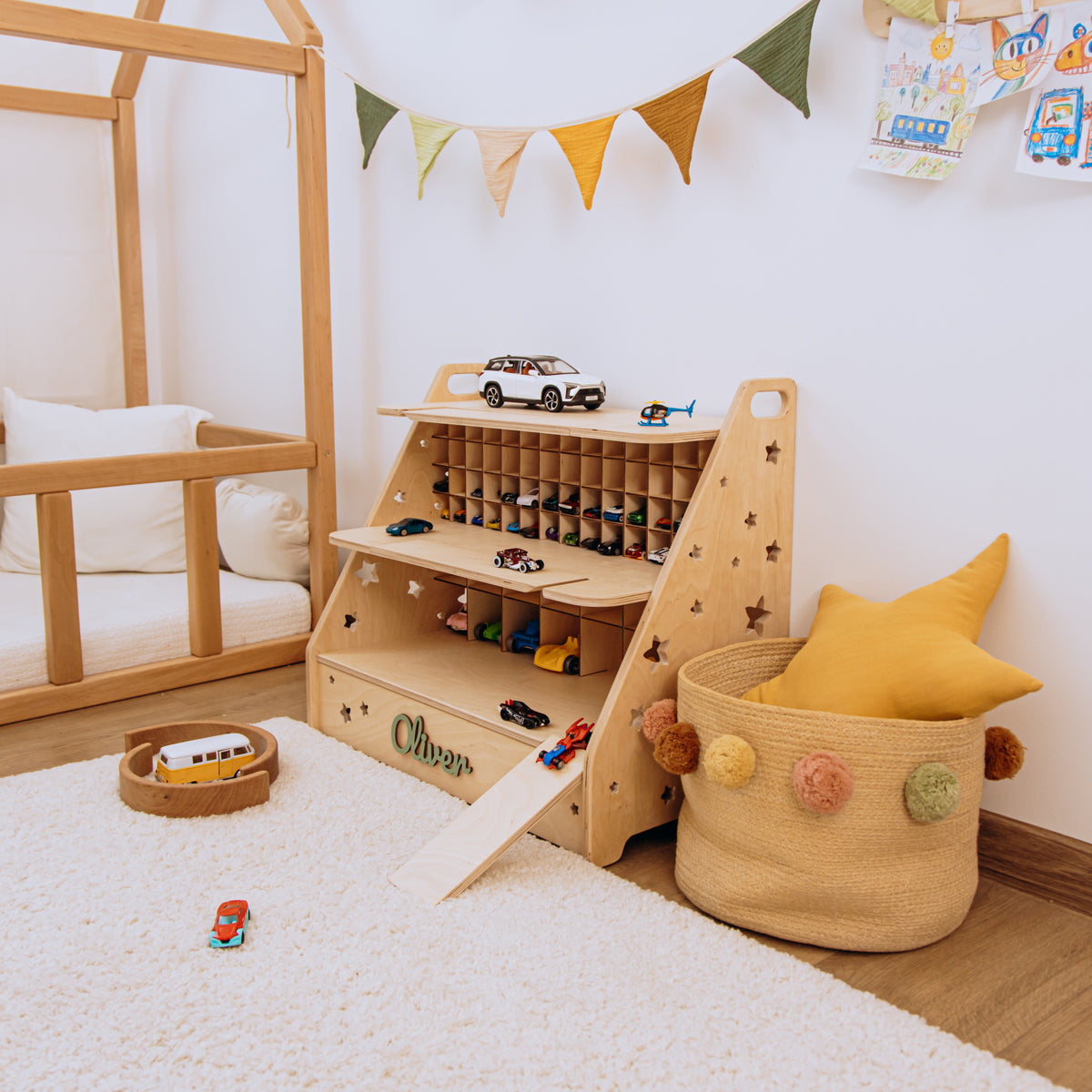 Light wood toy car garage with 70 cells in a Montessori playroom with white climbing frame