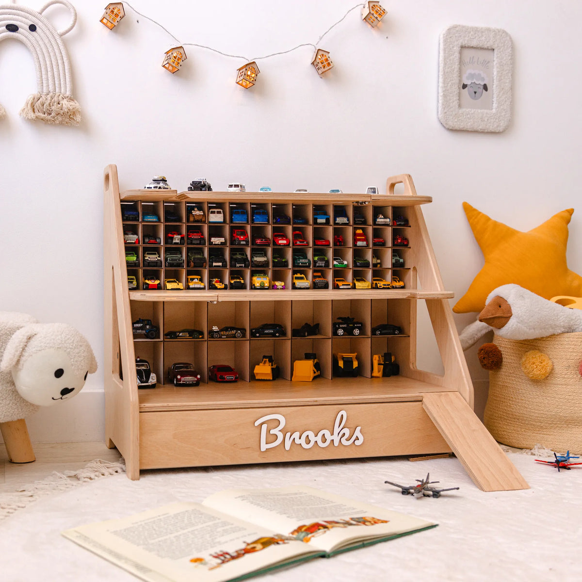 Light wood personalized car garage with the name Brooks in a decorated kids room