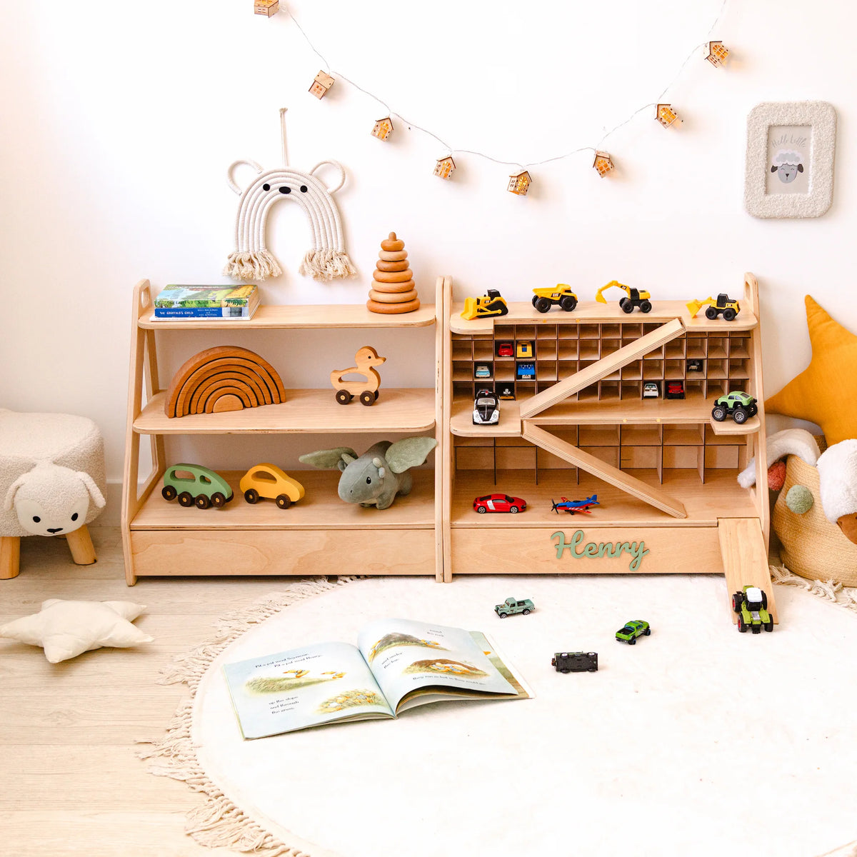 Light wood toy car garage and Montessori toy shelf set in a nursery with wooden cars, toys and the name Henry