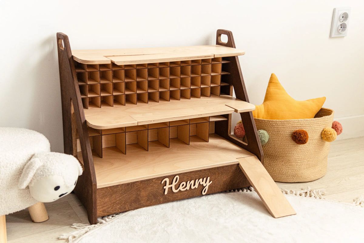 Dark wood personalized toy car garage with the name Henry in white 3D letters against a white wall