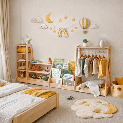 Light wood Montessori furniture set with clothing rack beside a house-frame floor bed in a kids room