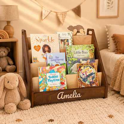 Dark wood Montessori bookshelf with 3D name in a cozy beige nursery with a plush bunny