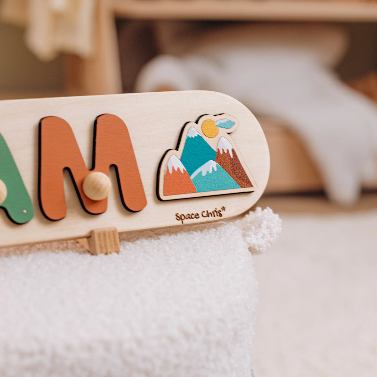 Close-up of a name puzzle with a mountain side element in a nursery