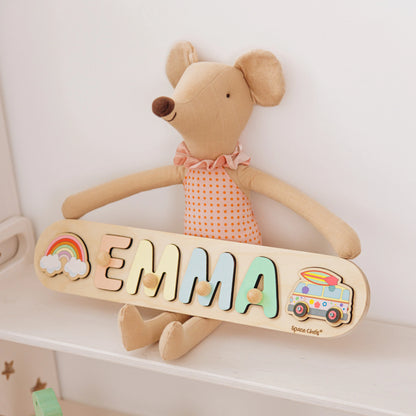 Wooden name puzzle with the name Emma and a camper van piece on a nursery shelf