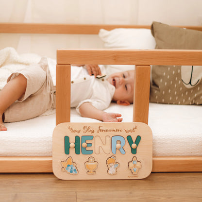 Baby near personalized Henry baptism name puzzle in crib