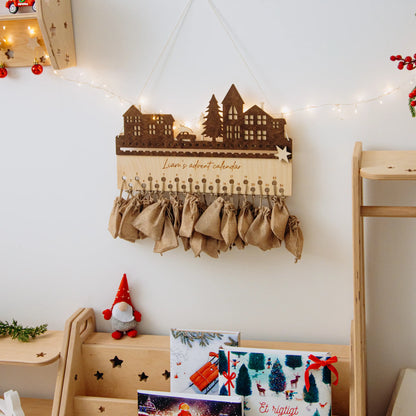 Wooden City design advent calendar displayed on a shelf with festive lights and holiday decor