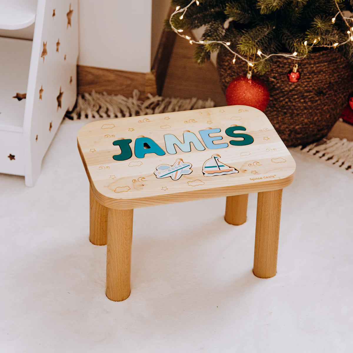 Custom wooden toddler step stool featuring the name James and printed Ocean theme elements near a Christmas tree.