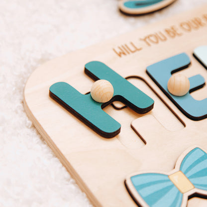 Close-up of wooden letter and bow tie piece on ring bearer puzzle