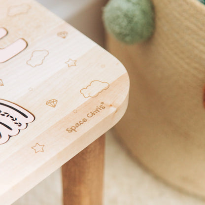Close up showing the smooth wooden edge and engraved details of the custom toddler step stool.