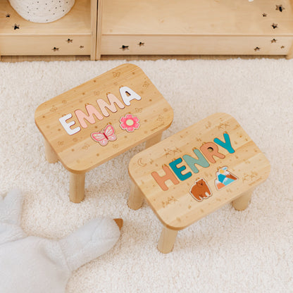 Two personalized wooden name puzzle stools showcasing different printed themes and name lengths.