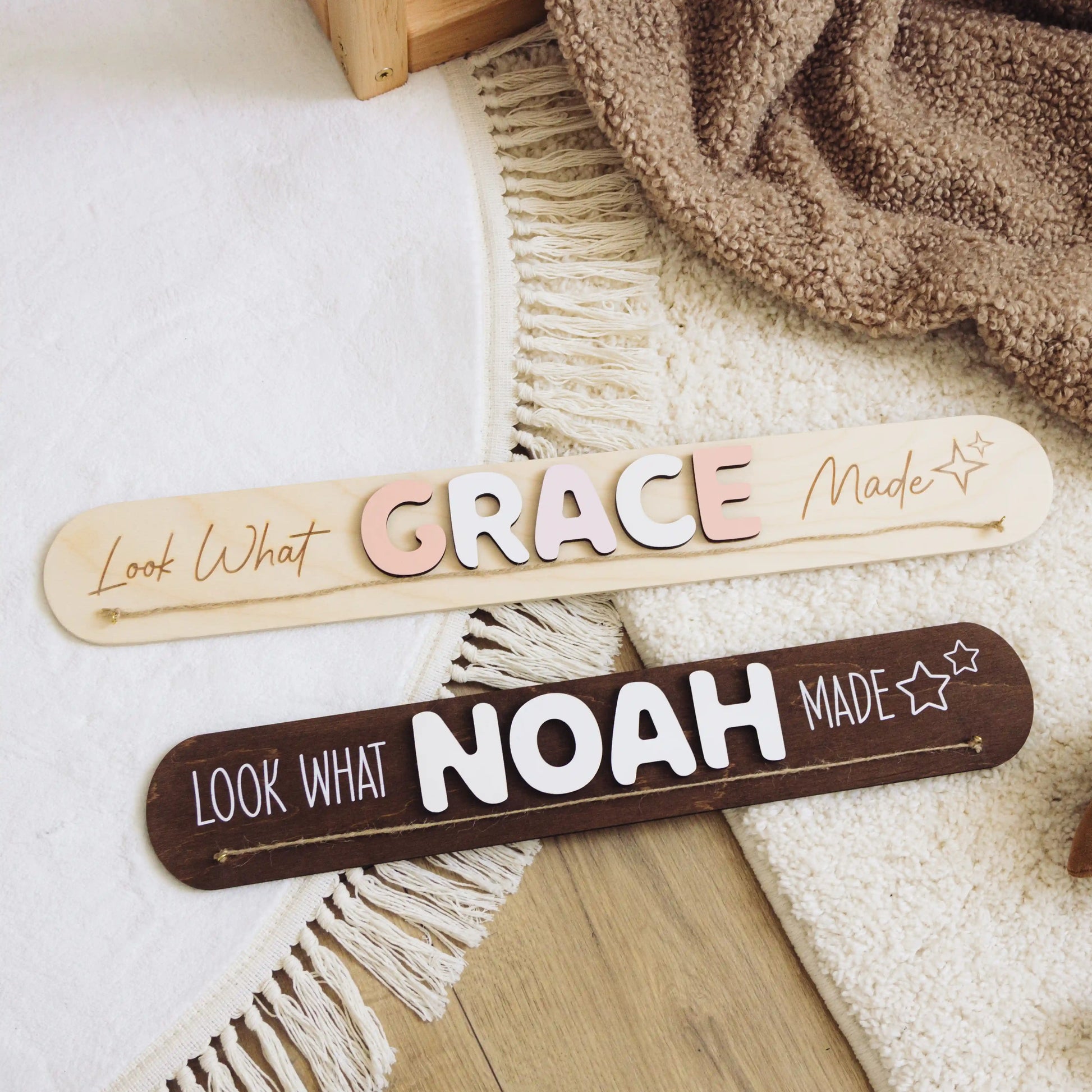 Dark wood Look What I Made signs with the names Grace and Noah on a woven blanket