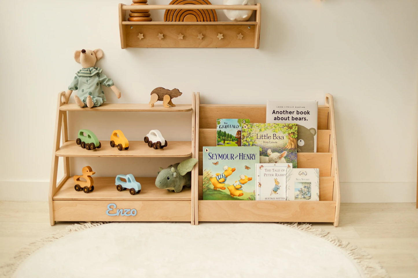 Personalized light wood Montessori toy shelf and bookshelf set with wooden toys, books and a teddy in a nursery