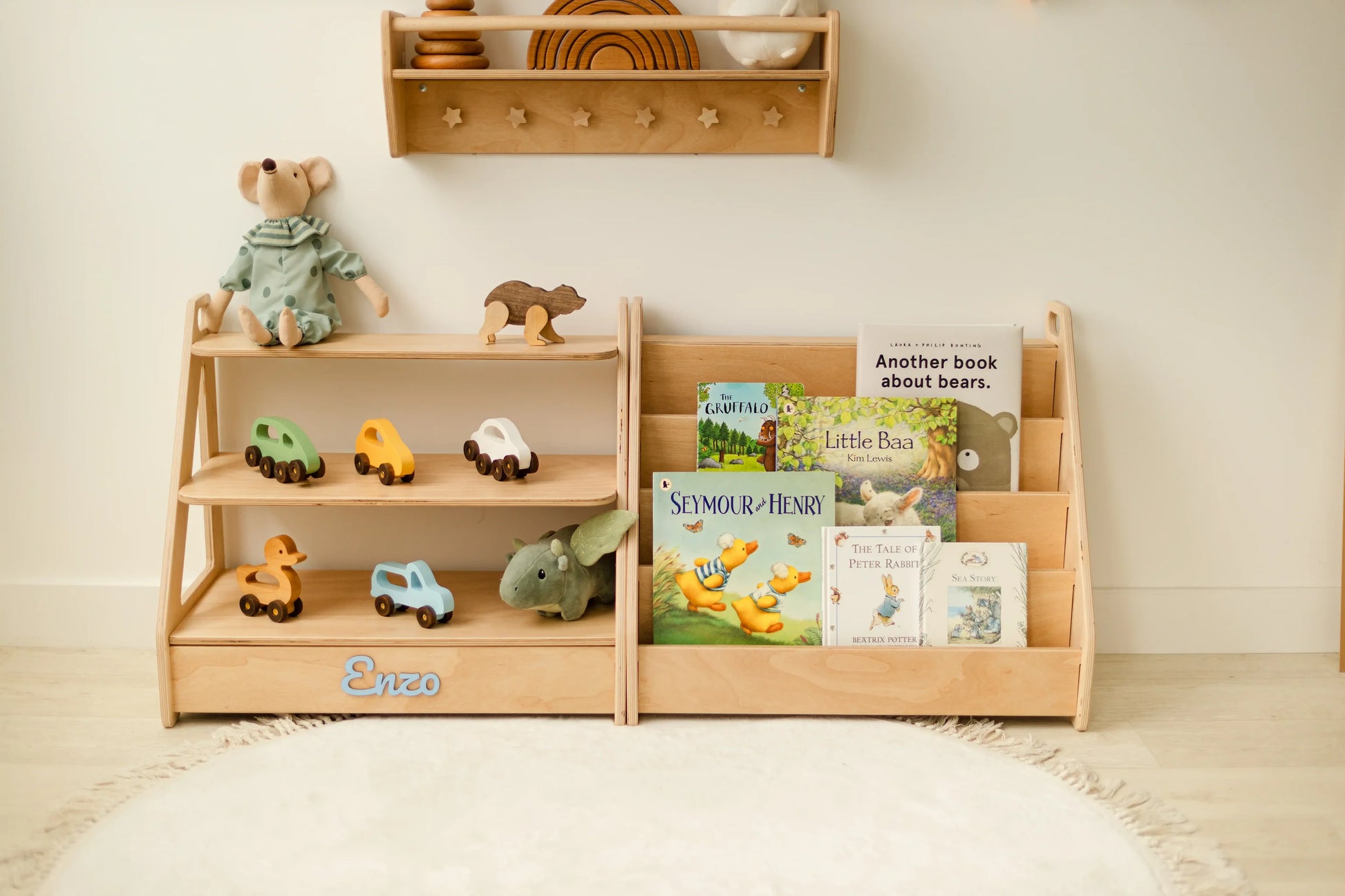 Personalized light wood Montessori toy shelf and bookshelf set with wooden toys, books and a teddy in a nursery