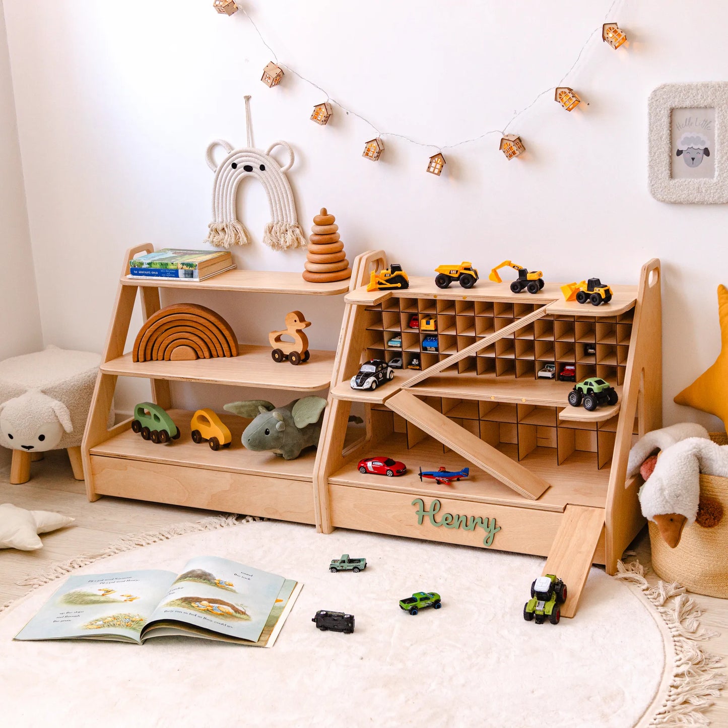 Personalized light wood toy car garage and toy shelf set with wooden cars and a teddy in a bright nursery