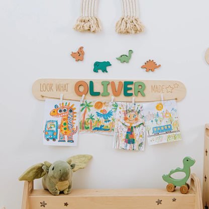 Light wood Look What I Made display with the name Oliver and colorful animal pieces holding children's drawings